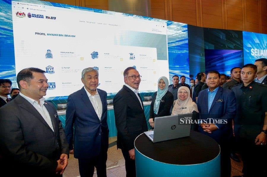 Prime Minister Datuk Seri Anwar Ibrahim with his deputy Datuk Seri Dr Ahmad Zahid Hamidi and Economic Minister Rafizi Ramli after the launch of Padu at the Putrajaya International Convention Centre (PICC), Putrajaya. -NSTP/AIZUDDIN SAAD