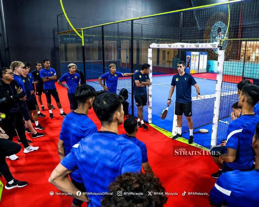 National youth coach Juan Garrido (between the goalposts) speaking to his players at the Padel Arena in City Center Doha Mall. PIC FROM FAM 