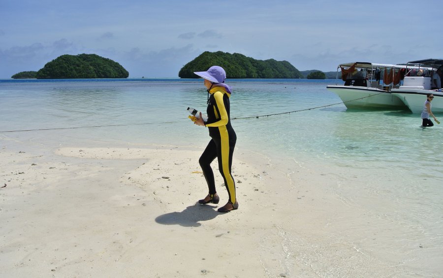 A Chinese tourist walking on a beach on the Rock Islands in Palau. - AFP pic
