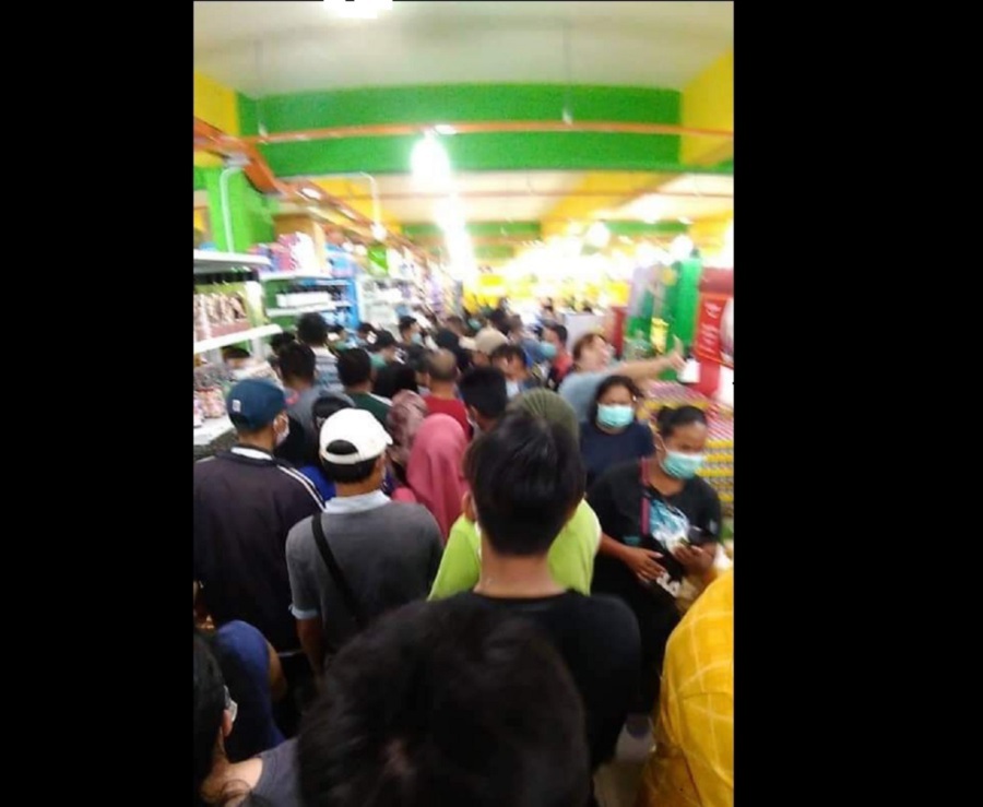Shoppers trying to get their hands on hand sanitisers on sale at a supermarket in Papar today. Pix courtesy of NST reader
