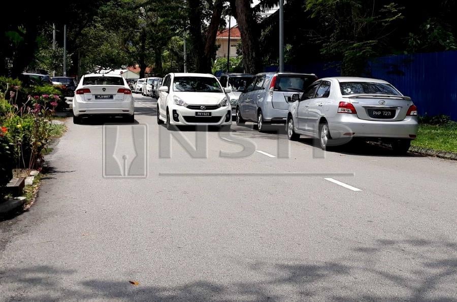 Residents staying near Jalan Westland, here, are upset with motorists for parking haphazardly near their housing area on weekdays. (NSTP/RAMDZAN MASIAM)