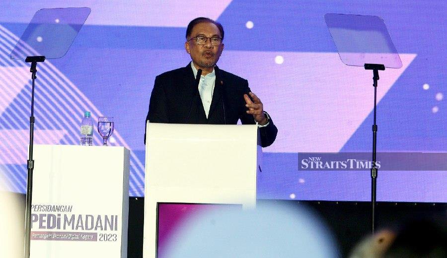 Prime Minister Datuk Seri Anwar Ibrahim delivers his keynote address during the launch of the Economy Digital Centres (PEDi) conference MADANI 2023 in Putrajaya. -NSTP/MOHD FADLI HAMZAH