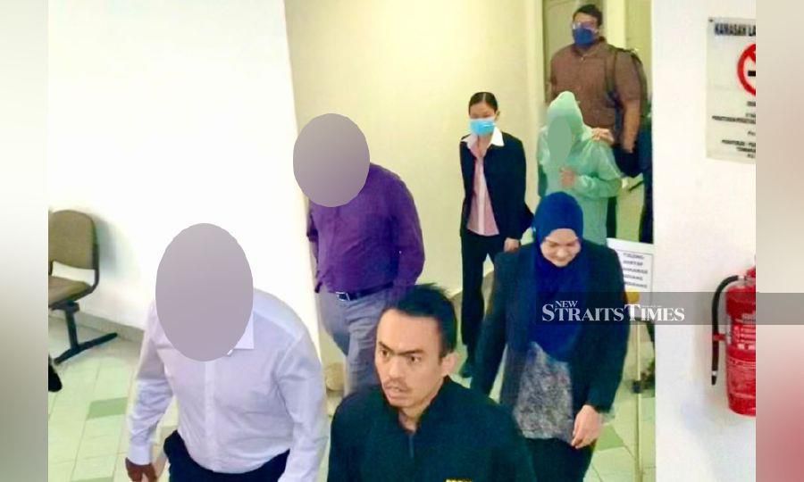 The accused are seen leaving the court following the trial. - Pic courtesy of MACC