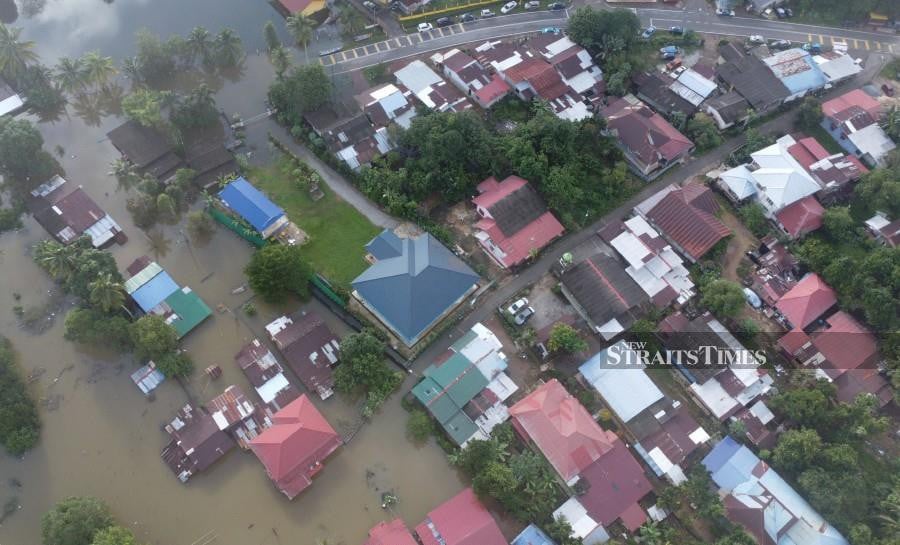 An aerial view of the floods ins Kampung Gual Tok Deh and Kampung Tersang, in Rantau Panjang. -NSTP/NIK ABDULLAH NIK OMAR