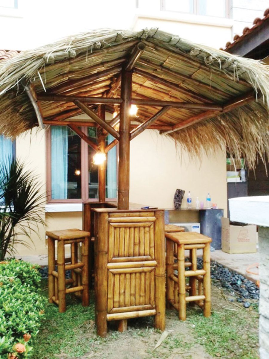 An outdoor bamboo bar with roof.
