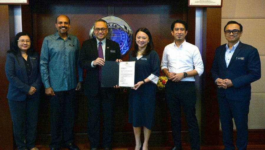 Abdul Rashid Yaakub (third from left) receiving his appointment letter as the new NSC director-general from Youth and Sports Minister Hannah Yeoh today. -- Pic courtesy of NSC 
