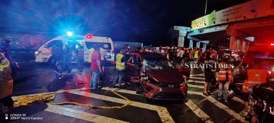 Rescuers help victims of the crash at the Tun Dr Lim Chong Eu Highway. - Pic courtesy of Fire and Rescue Dept 