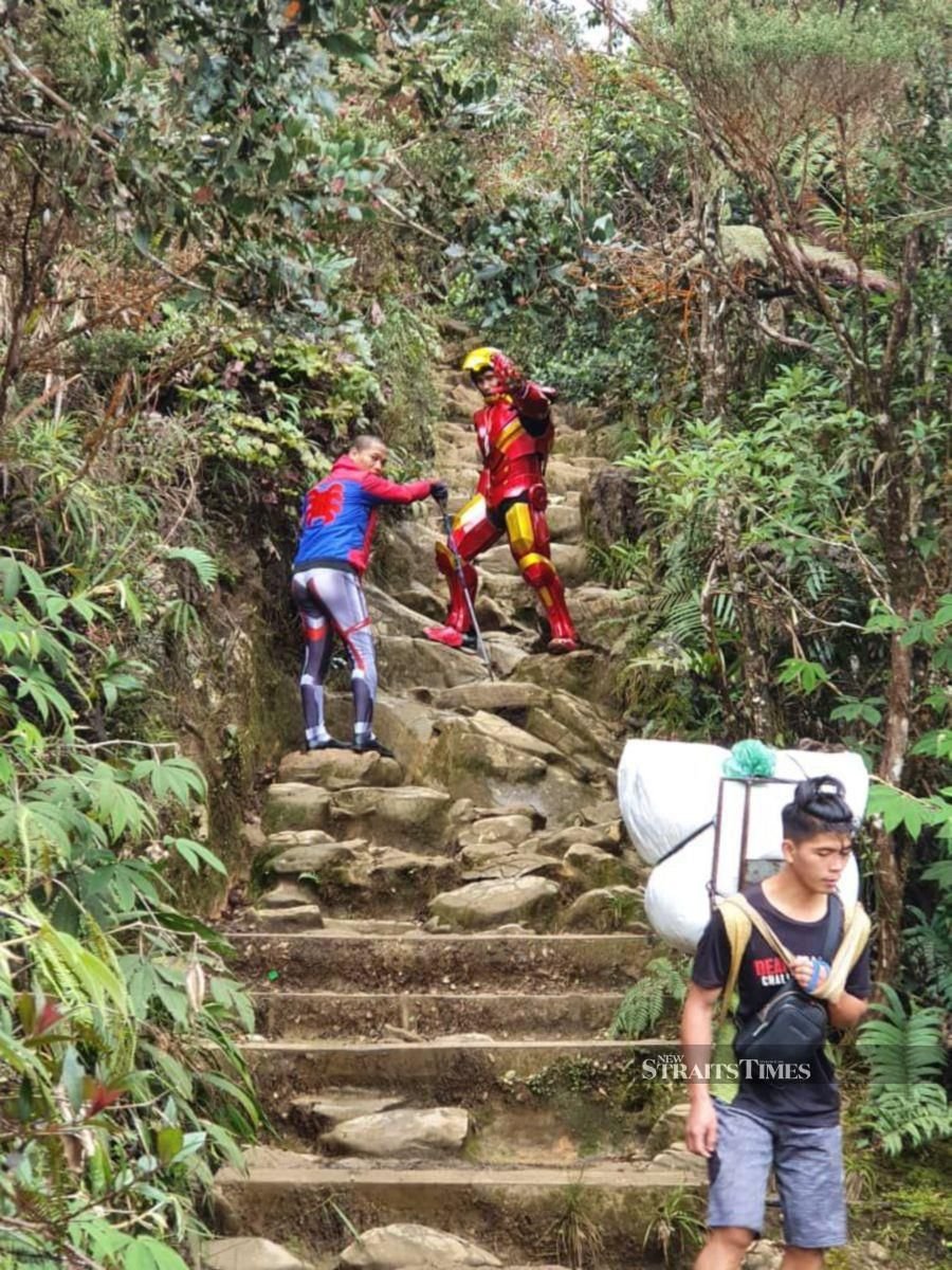 Iron man Yohan Charles Jayasuria and his team members led by Dr Randolf Paza (second left) climbed the Mount Kinabalu to raise fund for mountain guides affected with the Movement Control Order. -  NSTP/ courtesy of Dr Randolf Paza