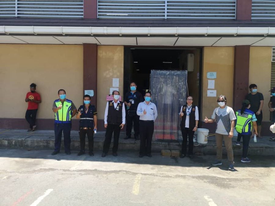 Penampang district council officers and health authorities testing out disinfecting cabin at the market this morning. - Pic courtesy of Tang Yang Ming 