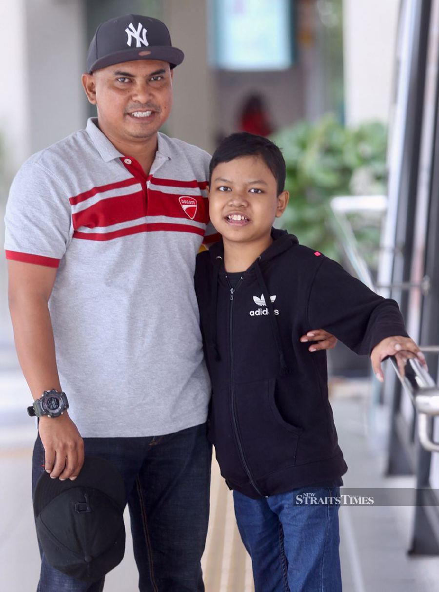 Megat Khairul Razin Khairul Annuar with his father, Khairul Annuar Ahmad Bustaman. - NSTP/FATHIL ASRI.