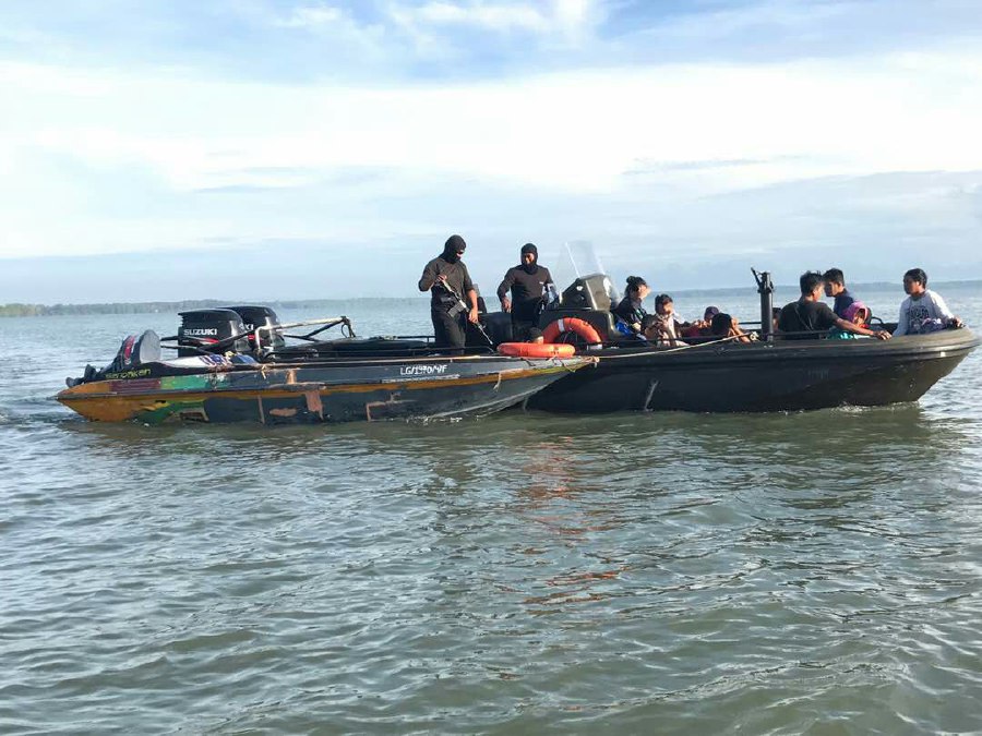 Marine police arrested eight Filipinos, a woman, aged between 23 and 62. They were trying to sneak into the state when marine patrol personnel spotted two suspicious boats at 5.30am. Pix courtesy of Marine police 