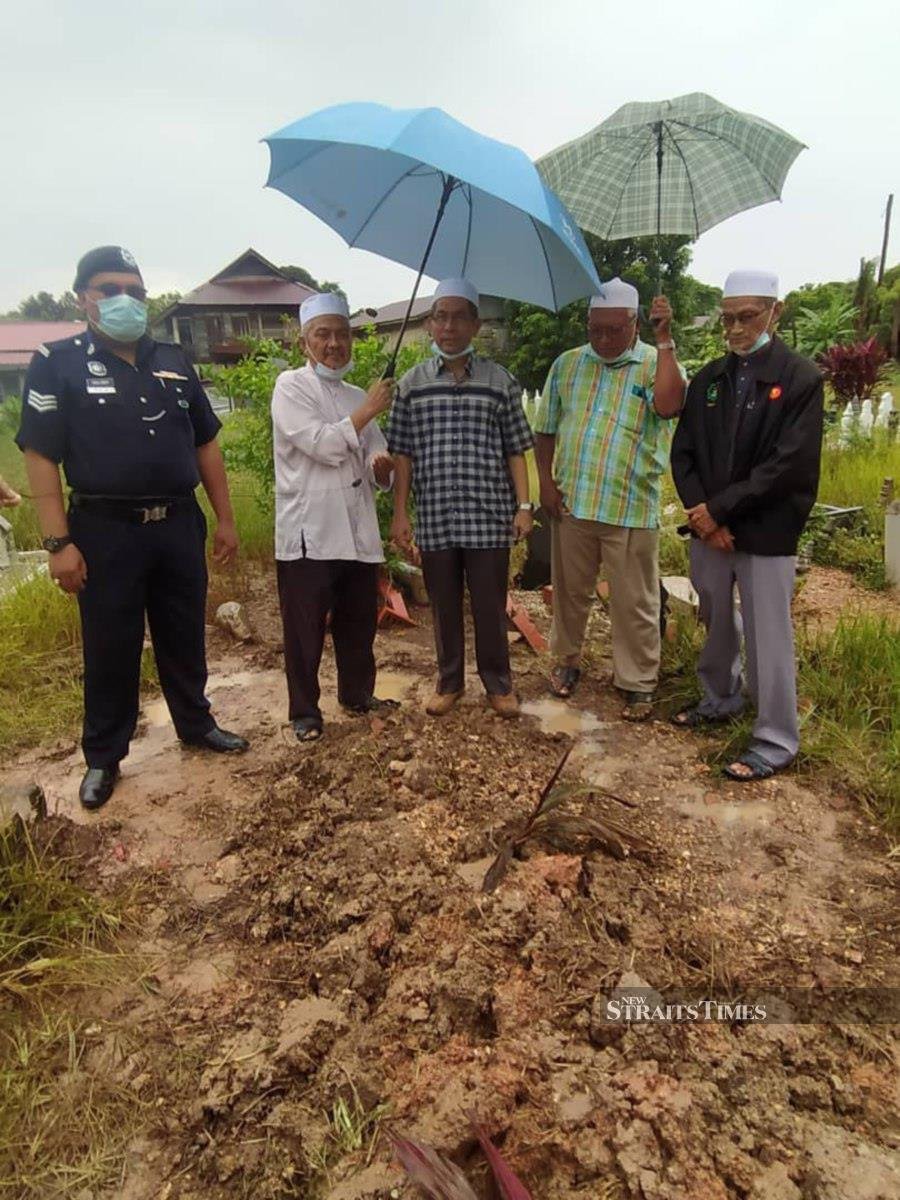 Kota Setar district religious officer Ahmad Faisol Omar (centre) and other representatives visiting the grave site in Derga today. -- Pix: NSTP/NOORAZURA ABDUL RAHMAN