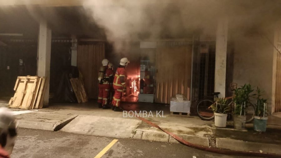 Firemen at the printing shop in Pudu, which was gutted by fire early this morning. - Pic courtesy of the KL Fire and Rescue Department
