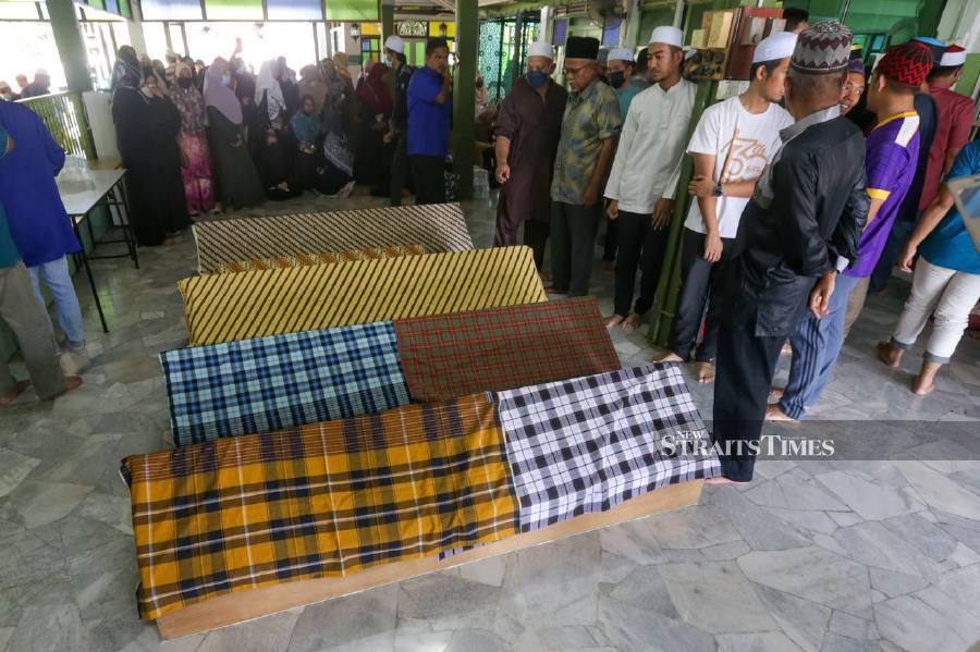 Their remains will be buried at the Masjid Jamek Haji Abdul Rashid cemetery in Sungai Dua after Zohor prayers. - NSTP/DANIAL SAAD
