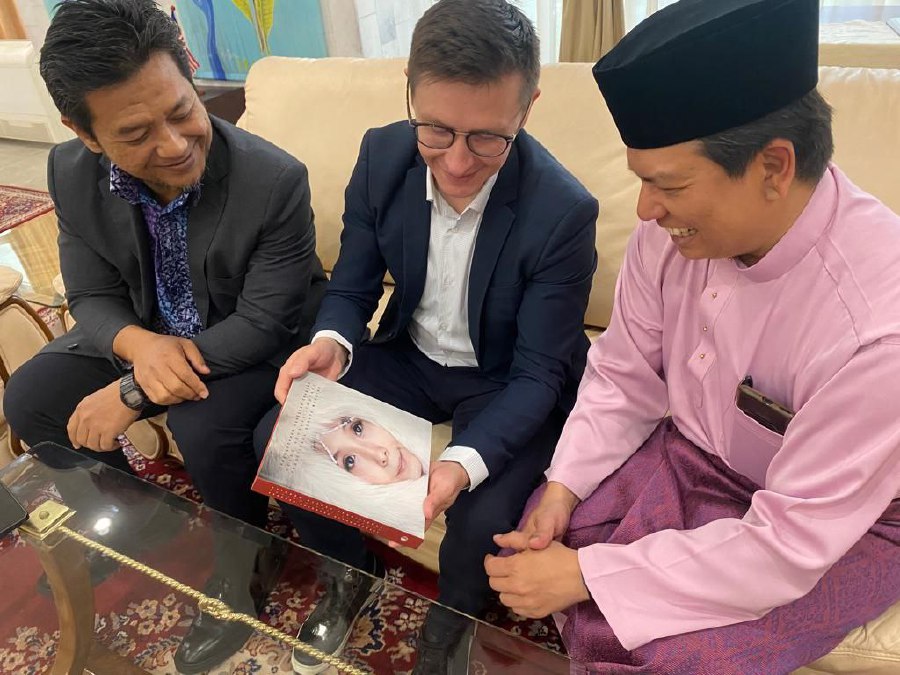 Denis Knyazev showing his book to Johan Ariff and Zulkifli Mohamed. - Pic courtesy of Dr Victor A. Pogadaev