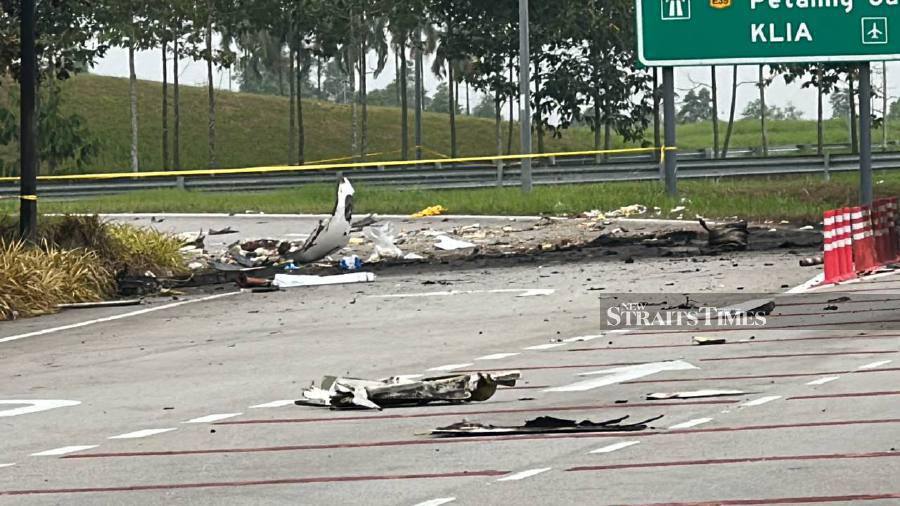 Debris is still strewn across the expressway and the site remains cordoned off by authorities following the air crash that involved a Beechcraft Model 390 (Premier 1) yesterday afternoon.- NSTP/Fuad Nizam