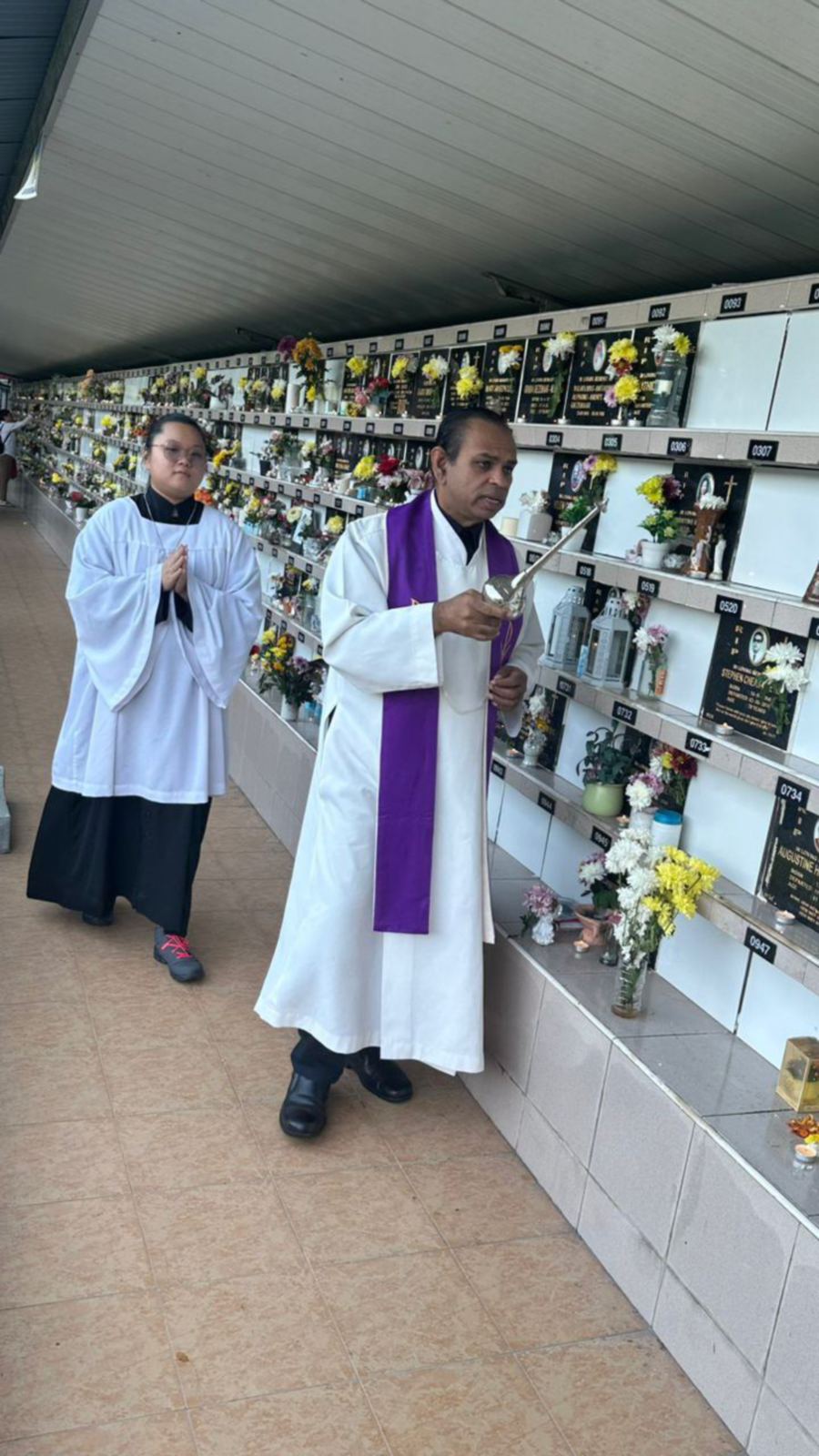 Monsignor Jude Miranda blesses the columbarium niches at the Kelawai Road Catholic Cemetery. - NSTP/Marina Emmanuel