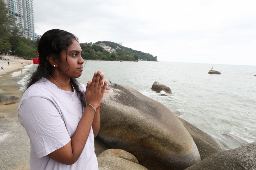 For the past 19 years, S. Thulaashi has never failed to offer special thanksgiving prayers annually for surviving the Boxing Day tsunami during interview at her parent's seaside cafe in Pantai Miami, Tanjung Bungah. - NSTP/MIKAIL ONG