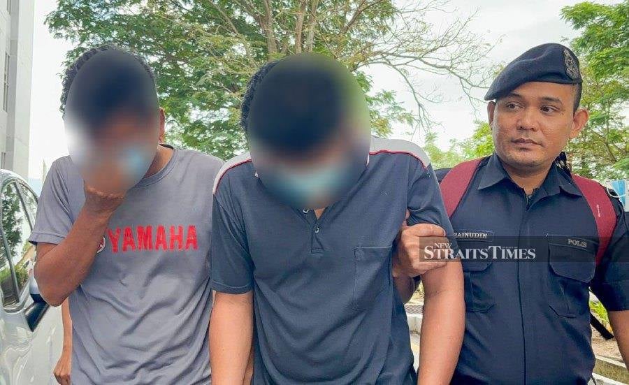 A lorry driver (center) pleaded not guilty in the Magistrate’s Court today to the charge of raping his 14-year-old daughter in a hotel last October. - NSTP/DANIAL SAAD