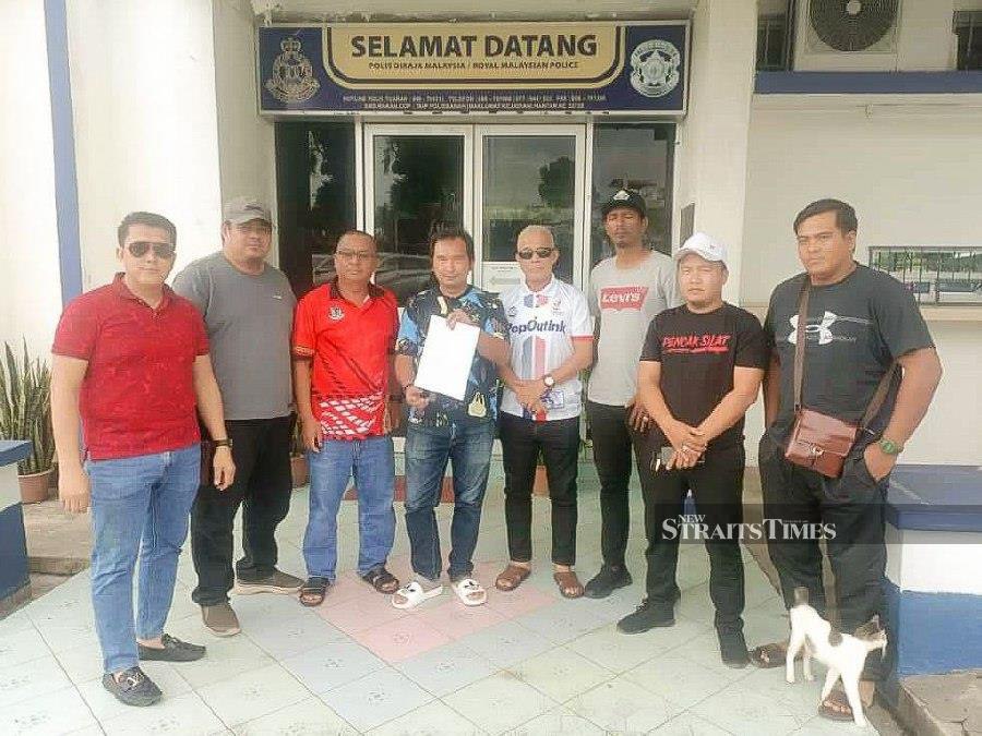 Through the police report filed by Chief Minister Datuk Seri Hajiji Noor’s son Mohd Reza (five from the right) in Tuaran, Nizam said it was hoped that an investigation can be conducted to bring the mastermind to justice. - NSTP/JOHARY INDAN