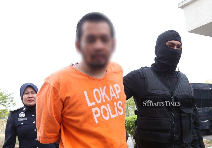 Clad in lock-up attire, the 38-year-old suspect arrived in court at about 8.35am.- NSTP/NIK ABDULLAH NIK OMAR