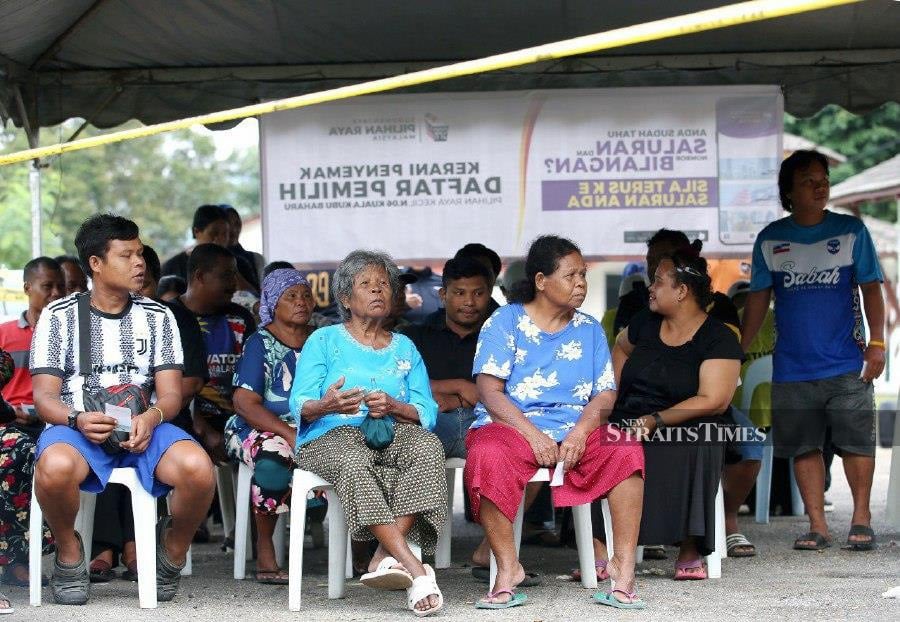 Some of the Orang Asli voters waiting to cast their votes at Pusat Pembangunan Pendidikan Peretak in Kampung Orang Asli Peretak. - NSTP/EIZAIRI SHAMSUDIN