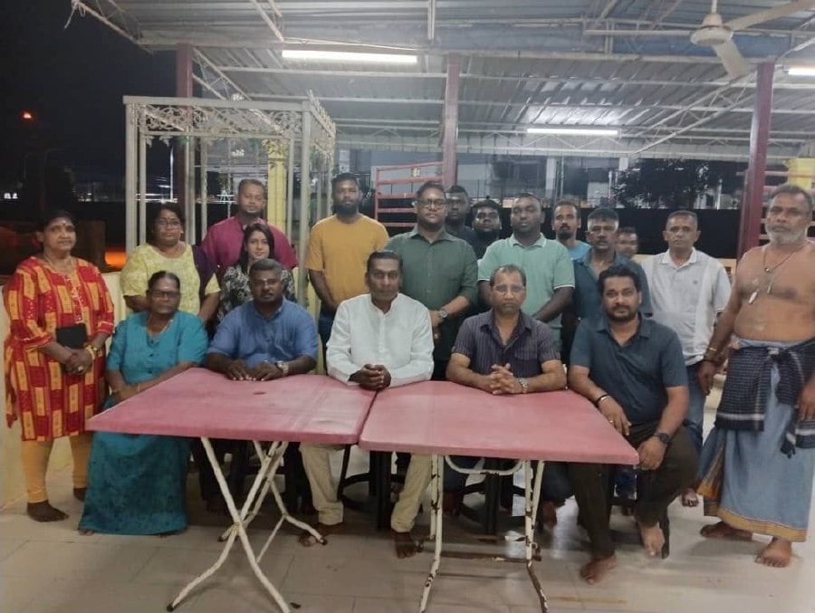  The Sri Maha Mariamman Temple chairman K Kheeshor Kumaar (centre, white) is urging the state government to provide a suitable alternative plot for the temple's reconstruction after receiving a notice to vacate the temple's current grounds. - COURTESY PIC