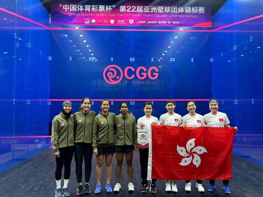 Malaysia and Hong Kong players pose for a photo before the Asian Team Squash Championships women’s final in Dalian, China, on Sunday. PIC CREDIT: SRAM 