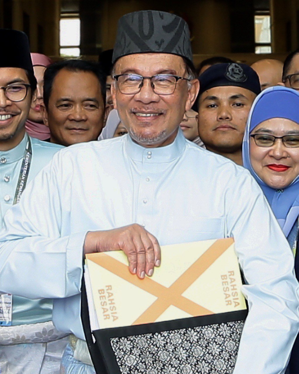 Prime Minister Datuk Seri Anwar Ibrahim poses with the the revised Budget 2023 book before heading to the parliament. - NSTP/MOHD FADLI HAMZAH