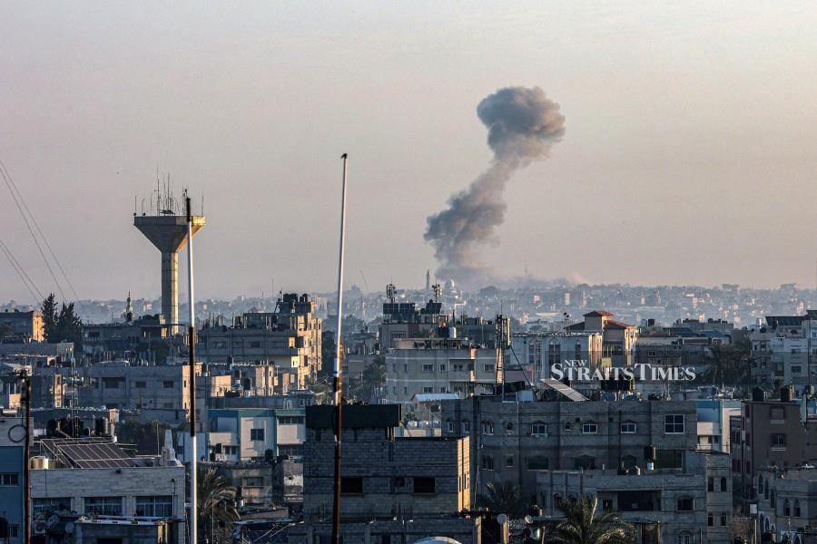 This photograph taken from Rafah shows smoke billowing over Khan Yunis in the southern Gaza Strip. - AFP PIC