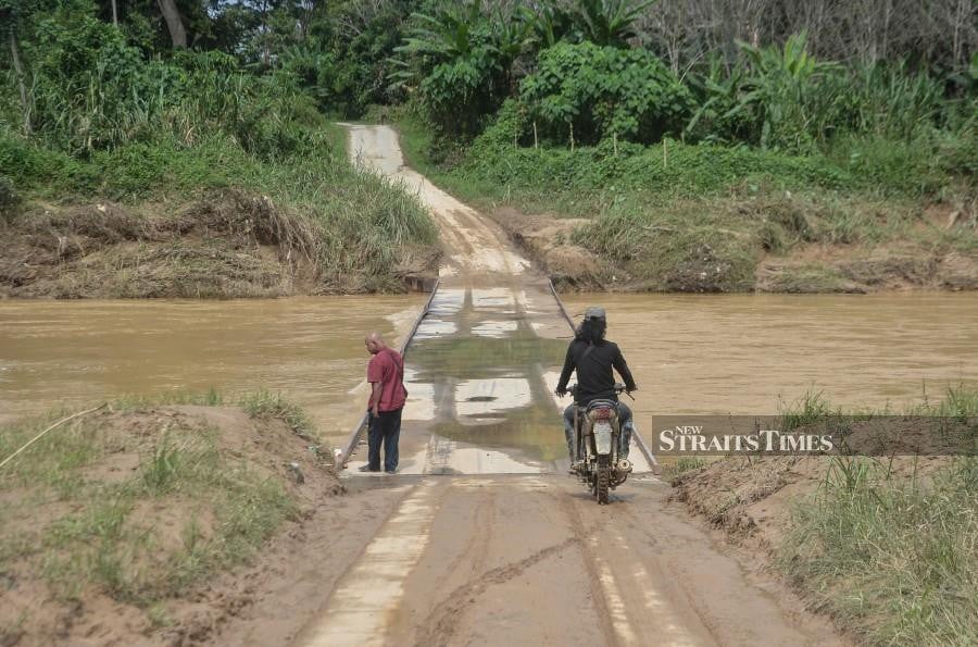 Residents of Kampung Batu 6 says the bridge is not passable for three times even if it rains for only a day or less. - BERNAMA PIC