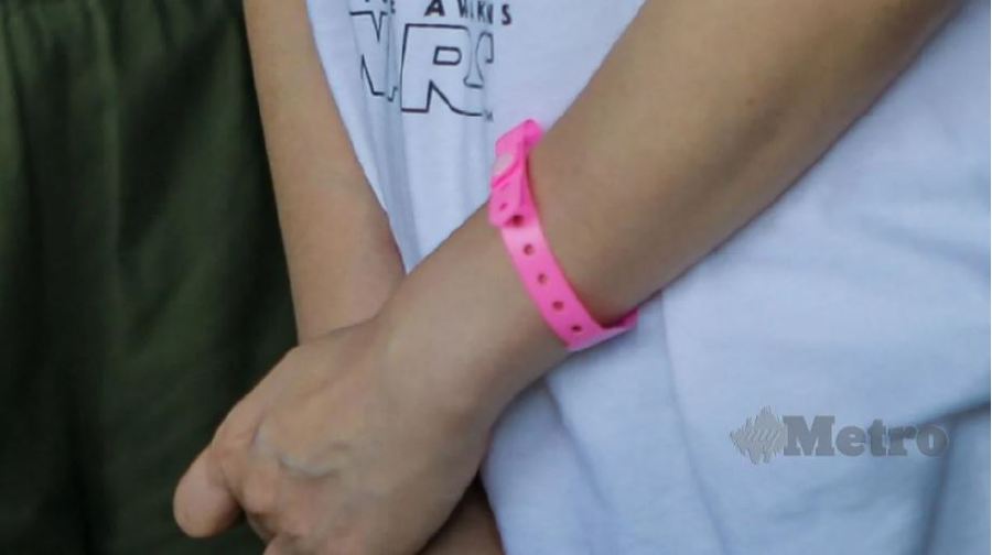 Two men wearing pink bracelets issued by the Ministry of Health were among five individuals compounded today for breaching the standard operating procedures (SOP) since the Movement Control Order (MCO) was re-implemented on Jan 13. - File pic, for illustration purposes only