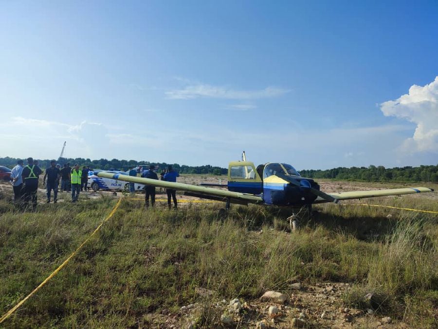The aircraft made an emergency landing in an open space near Port Klang. - Pic courtesy of Fire and Rescue Dept. 