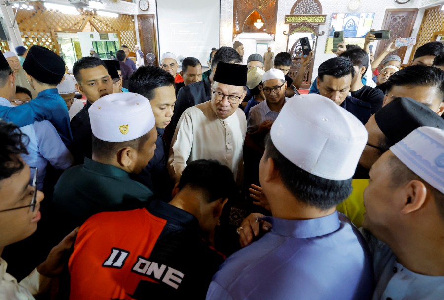 Prime Minister Datuk Seri Anwar Ibrahim spends time speaking to the congregation after performing Friday prayers Al-Furqan Surau in Presint 11, Putrajaya. - BERNAMA PIC