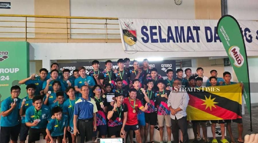 Winning teams pose with their medals at the National Water Polo Championships yesterday.- Pic by Amin Jalil