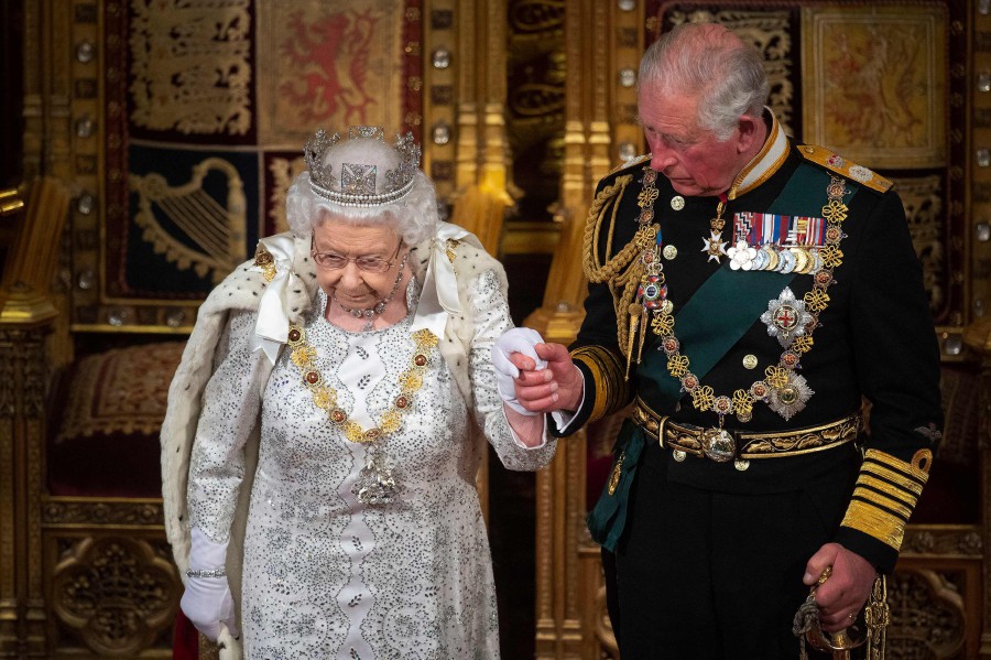 In this file photo taken on October 14, 2019 Britain's Queen Elizabeth II (L) leaves with Britain's Prince Charles, Prince of Wales (R) after delivering the Queen's Speech at the State Opening of Parliament in the Houses of Parliament in London on October 14, 2019. - AFP PIC