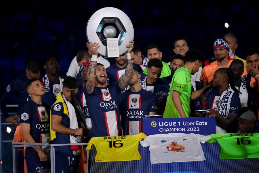 Paris Saint-Germain's Sergio Ramos raises the trophy to celebrate their French L1 championship during the 2022-2023 Ligue 1 trophy ceremony the match against Clermont at the Parc des Princes Stadium in Paris. - AFP PIC
