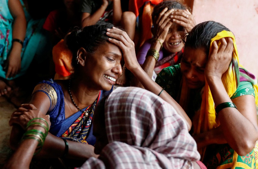 Women mourn the death of their relatives, after a landslide hit a village in Raigad, in the western Indian state of Maharashtra, India. -REUTERS PIC
