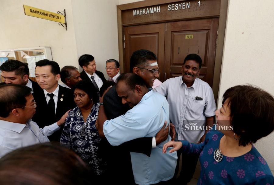 Jelutong MP and lawyer RSN Rayer is hugged by a family member of Seremban Jaya assemblyman P Gunasekaran outside the Seremban Sessions Court. - NSTP/Iqmal Haqim Rosman