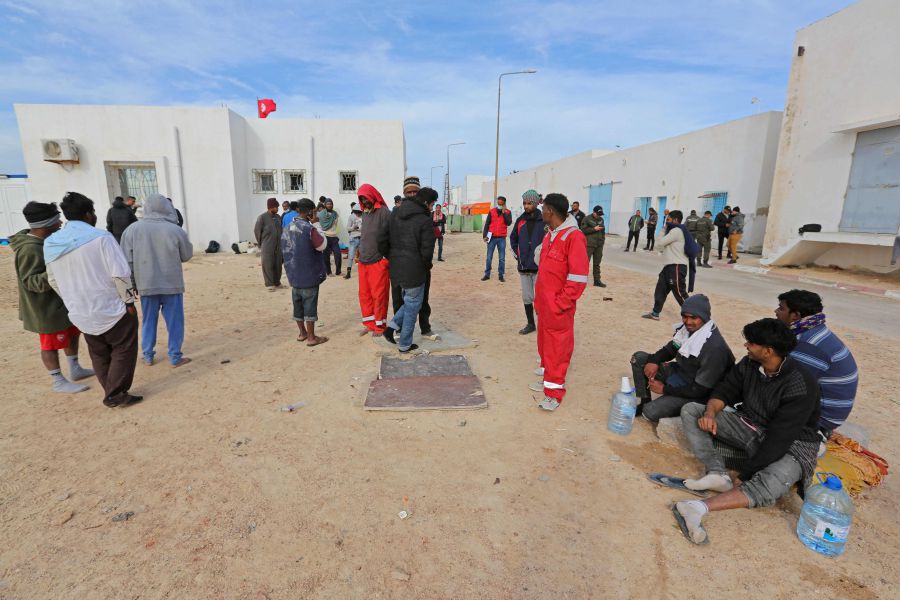 Migrants rescued by Tunisia's national guard during an attempted crossing of the Mediterranean by boat, rest on the beach at the port of el-Ketef in Ben Guerdane in southern Tunisia near the border with Libya, on January 6, 2022. - AFP PIC