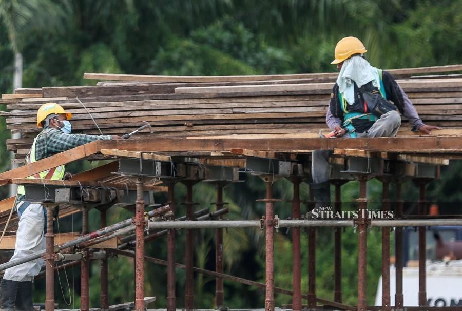 A file pic dated Jan 13, 2023, shows foreign workers at a construction site in Nibong Tebal. - NSTP file pic