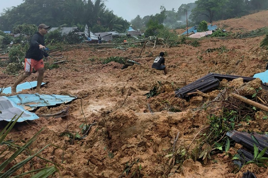 People inspect the site where a landslide hit a village on Serasan Island, Natuna regency, Indonesia. - AP PIC