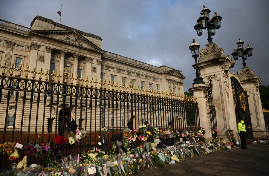 Flowers and tributes are pictured outside of Buckingham Palace in London on September 9, 2022, a day after Queen Elizabeth II died at the age of 96. - AFP PIC