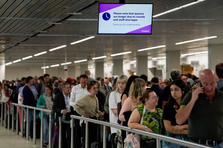 Travelers wait in long lines to check in and board flights at Amsterdam's Schiphol Airport, Netherlands, on June 21, 2022.  - AP PIC