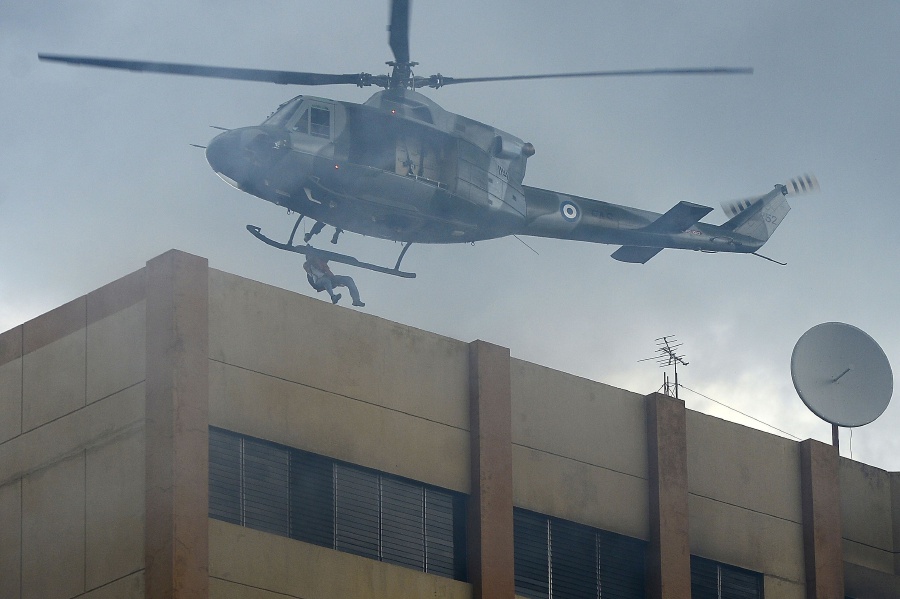 A military helicopter rescues people trapped on the roof of the Ministry of Finance by an intense fire in San Salvador. AFP
