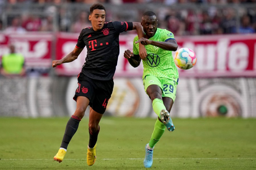 Bayern's Jamal Musiala vies for the ball with Wolfsburg's Josuha Guilavogui, right, during the German Bundesliga soccer match between FC Bayern Munich and VfL Wolfsburg in Munich, Germany. - AP PIC