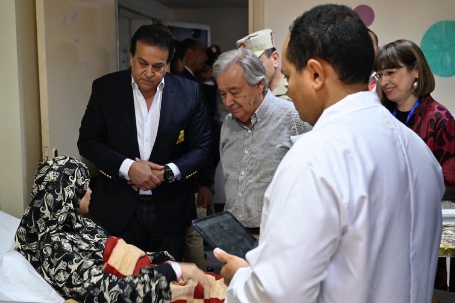 UN Secretary-General Antonio Guterres meeting with a Palestinian woman evacuated from the Gaza Strip receiving treatment at the general hospital in El-Arish in Egypt's northeastern North Sinai province. - AFP PIC