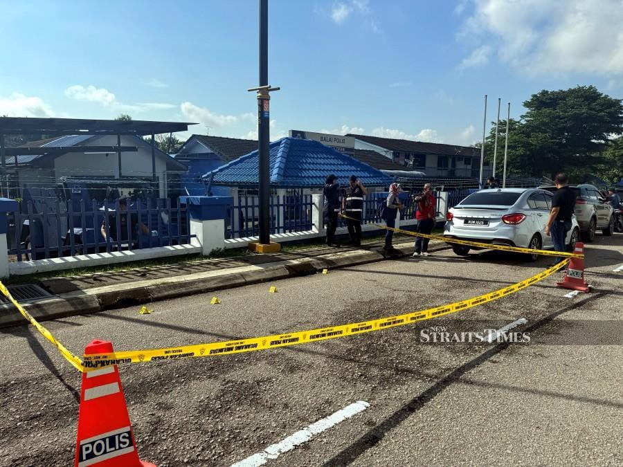 A file pic dated May 17, shows forensic officers sweeping the crime scene for evidence at the Ulu Tiram police station, Johor. -NSTP/NUR AISYAH MAZALAN