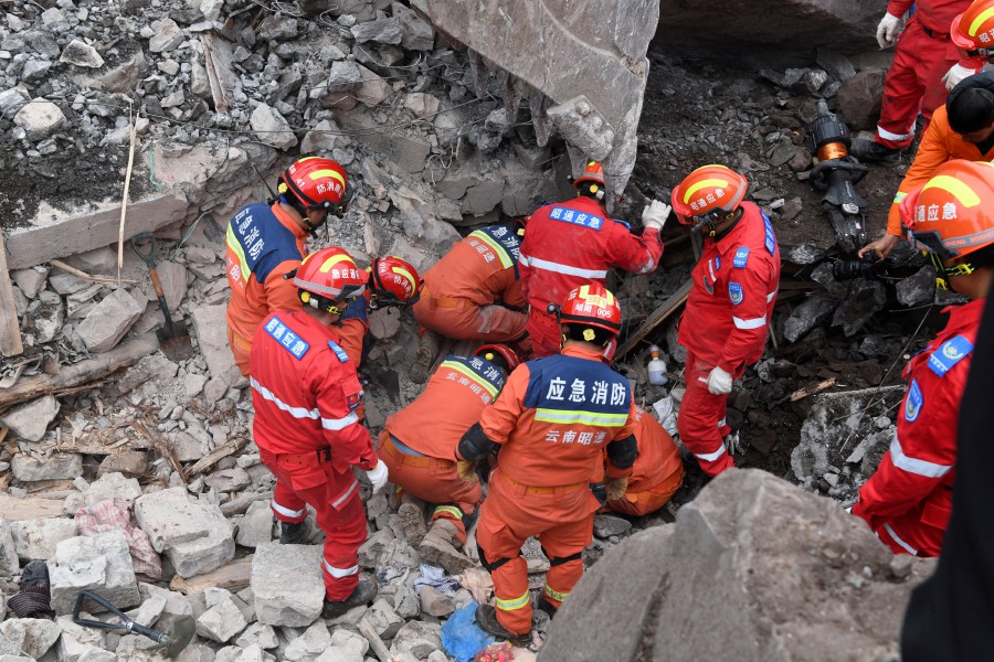 Rescue workers search for survivors in the debris after a landslide hit Zhenxiong County, in Zhaotong, Yunnan province, China. - REUTERS PIC
