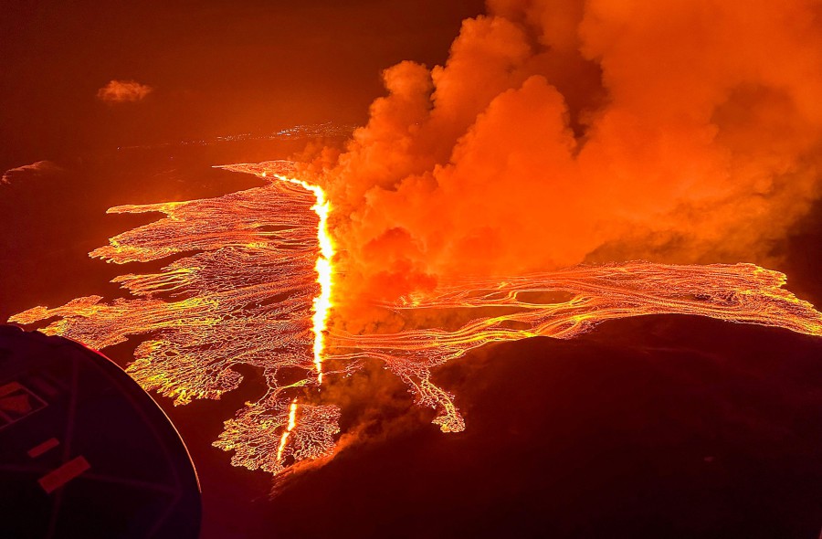 Billowing smoke and flowing lava pouring out of a new fissure during a new volcanic eruption on the outskirts of the evacuated town of Grindavik, western Iceland. - AFP PIC